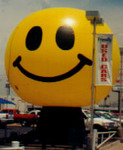giant 25ft sphere shape cold-air balloon with smiley face artwork